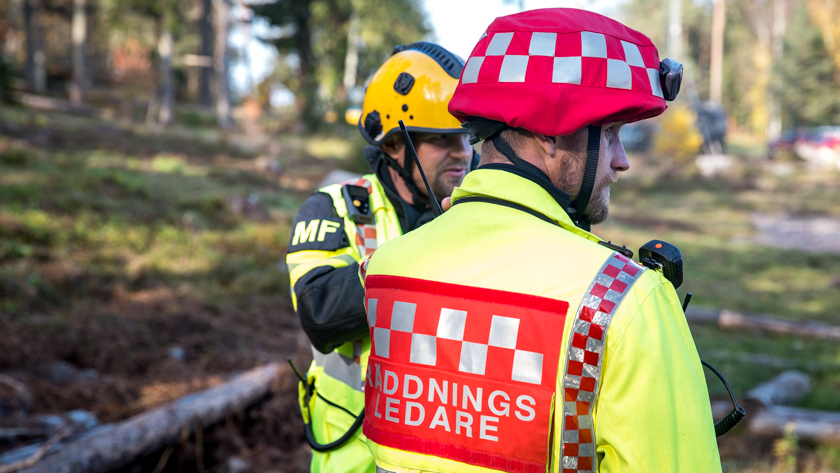 Insatsledare ute på skadeplats med röd hjälm och texten Räddningsledare på ryggen